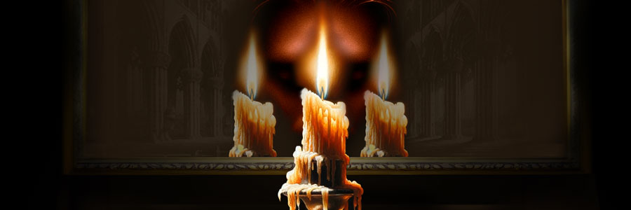A man prays in front of a candle reflected in a drawing of a church